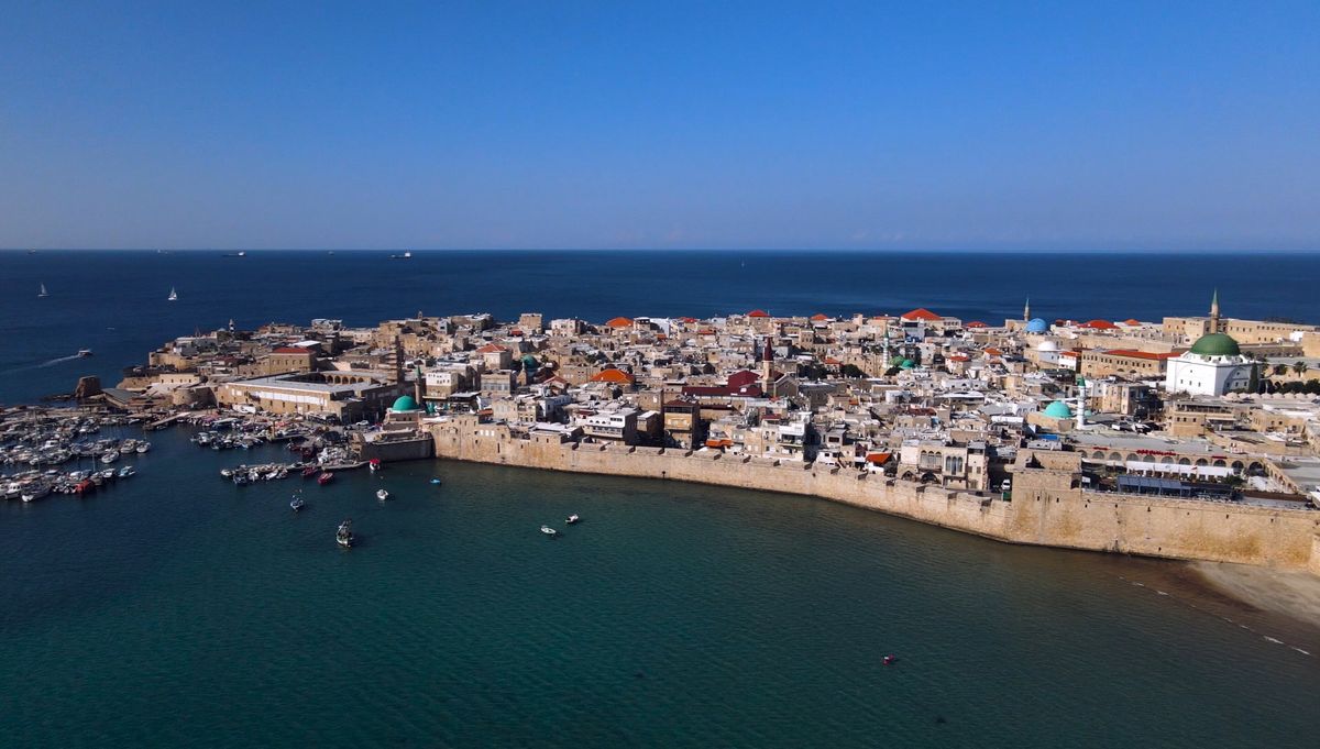 Aerial drone view of the Old City of Akko with the harbor, sea walls, and Al-Jazzar Mosque