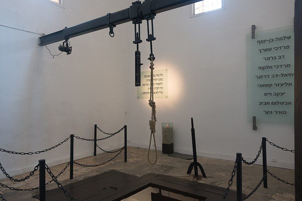 The gallows room at the Akko Citadel prison with the noose and the names of the executed fighters on the wall