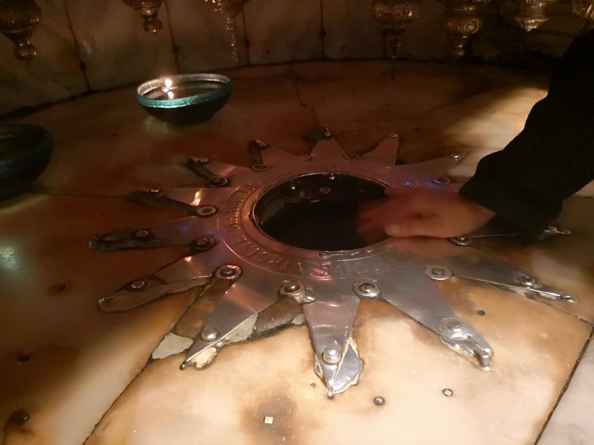The 14-pointed silver star in the Grotto of the Nativity in Bethlehem