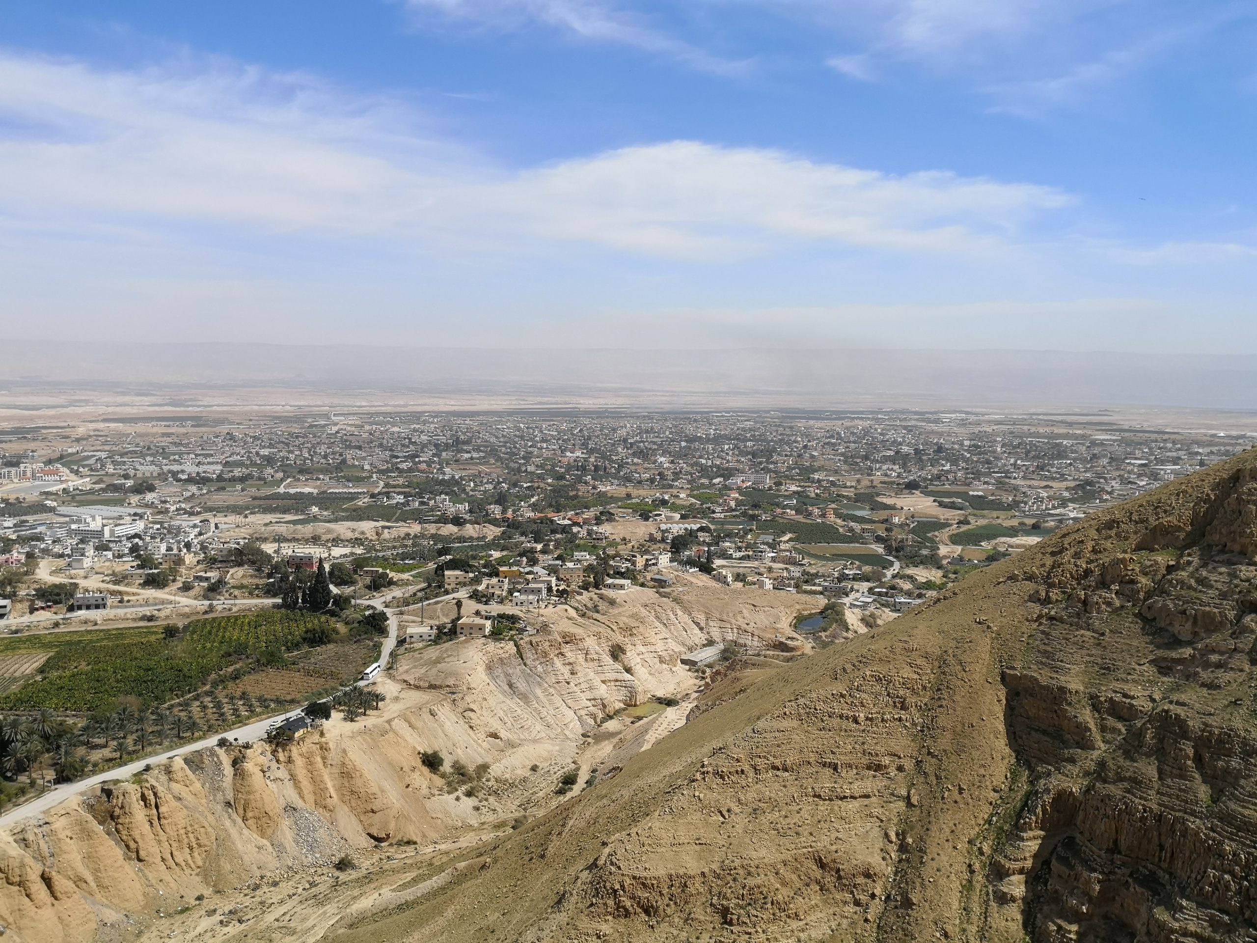 View of Jericho oasis from the cliffs above, with the Jordan Valley and mountains of Moab