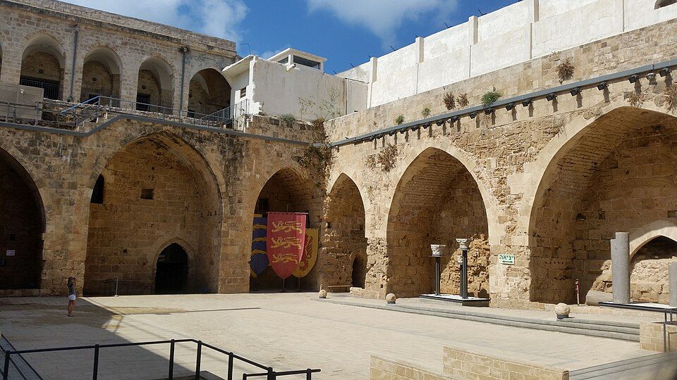 The Crusader courtyard of the Knights Halls in Akko with pointed arches and heraldic shields