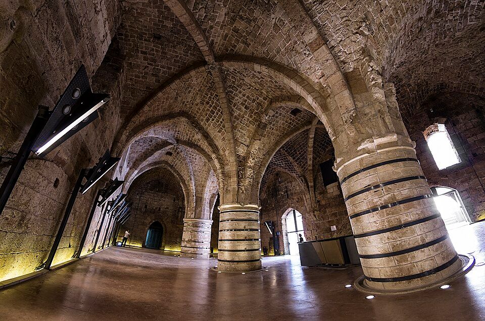 The vaulted Gothic interior of the Knights Halls in Akko with massive stone columns