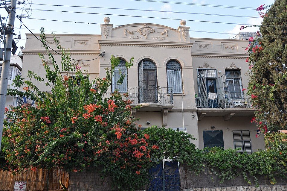 A restored historic building with bougainvillea in Neve Tzedek