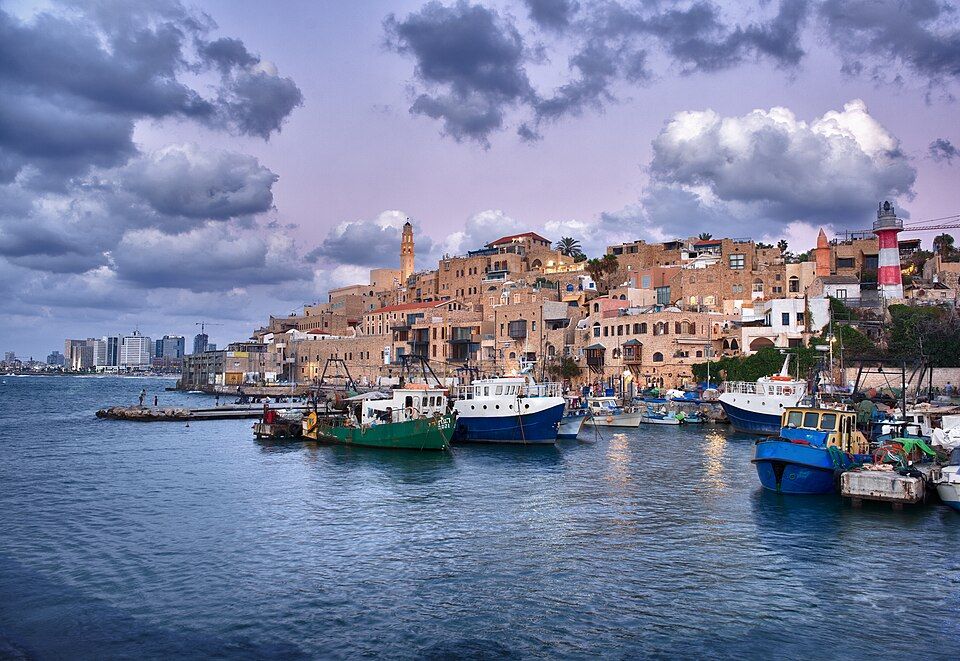 Old Jaffa port with fishing boats and the ancient city on the hill