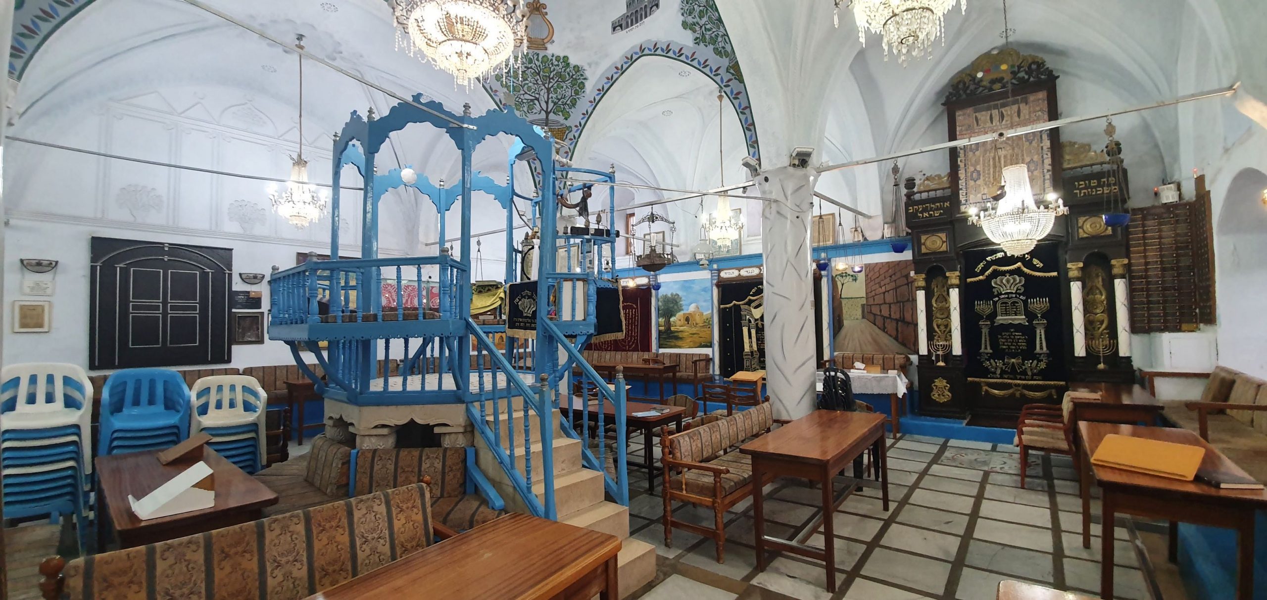 Interior of Abuhav Synagogue in Safed showing the blue bimah, painted ceiling and holy arks