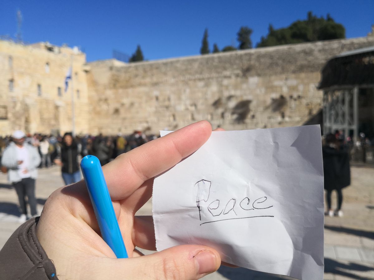 A prayer note reading Peace at the Western Wall in Jerusalem