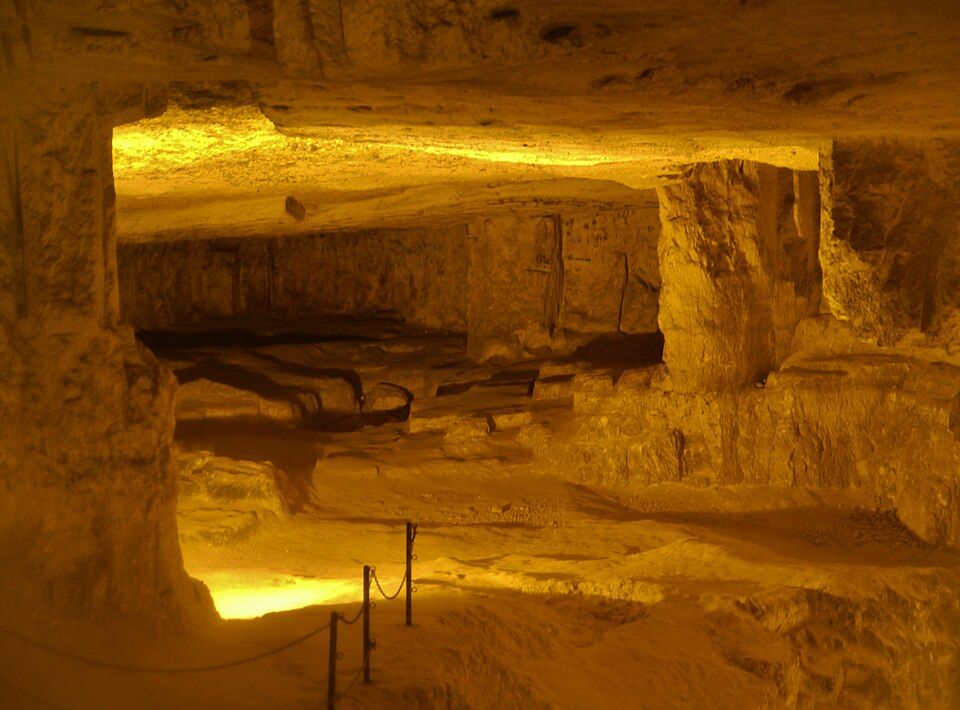 Inside Zedekiahs Cave showing ancient quarry marks and limestone pillars beneath Jerusalem
